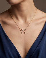 Delicate bow pendant necklace featuring 0.40ct diamonds and refined 18K yellow gold detailing | SARATTI