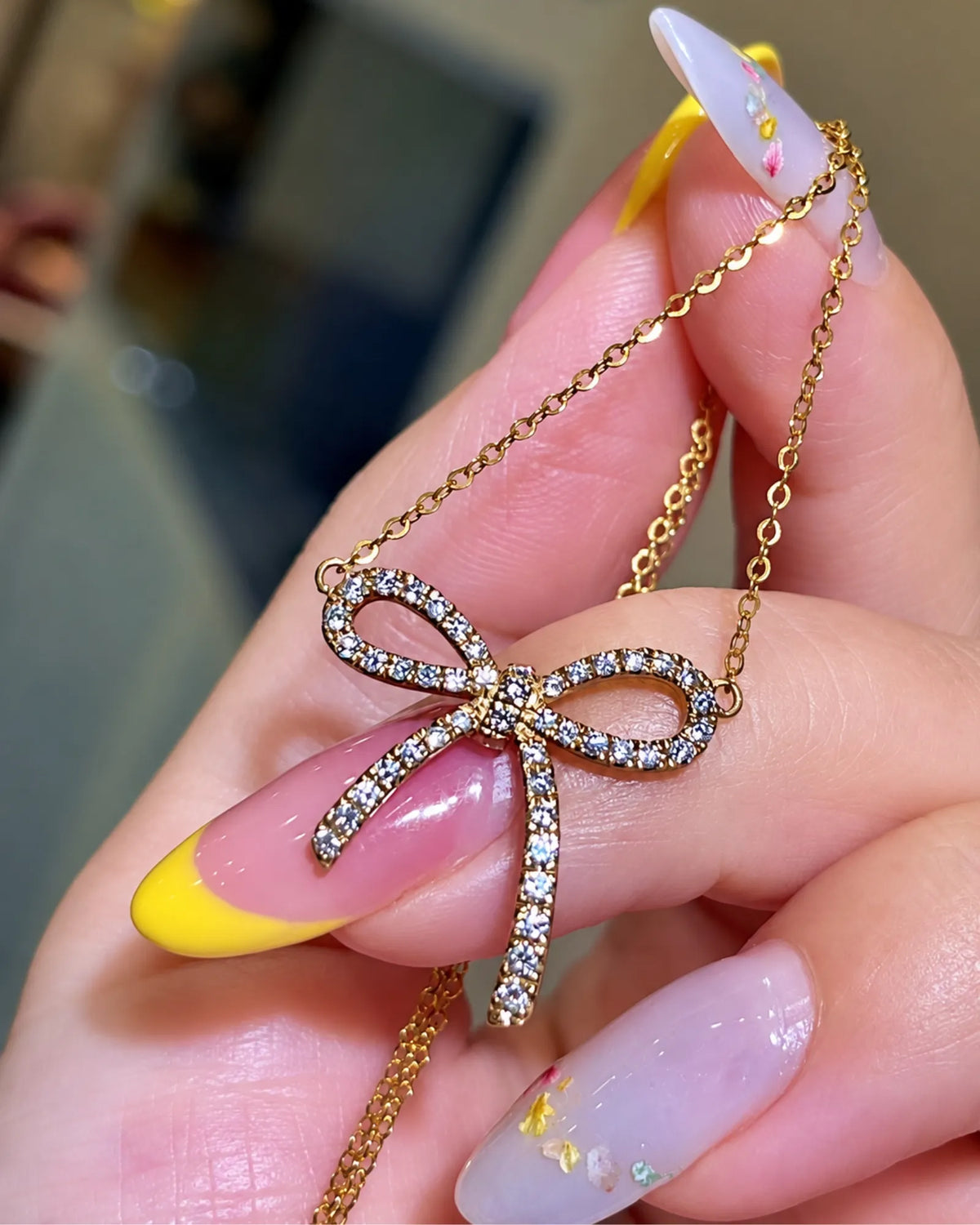 Diamond bow necklace in 18K yellow gold for elegant everyday wear and romantic gifting | SARATTI
