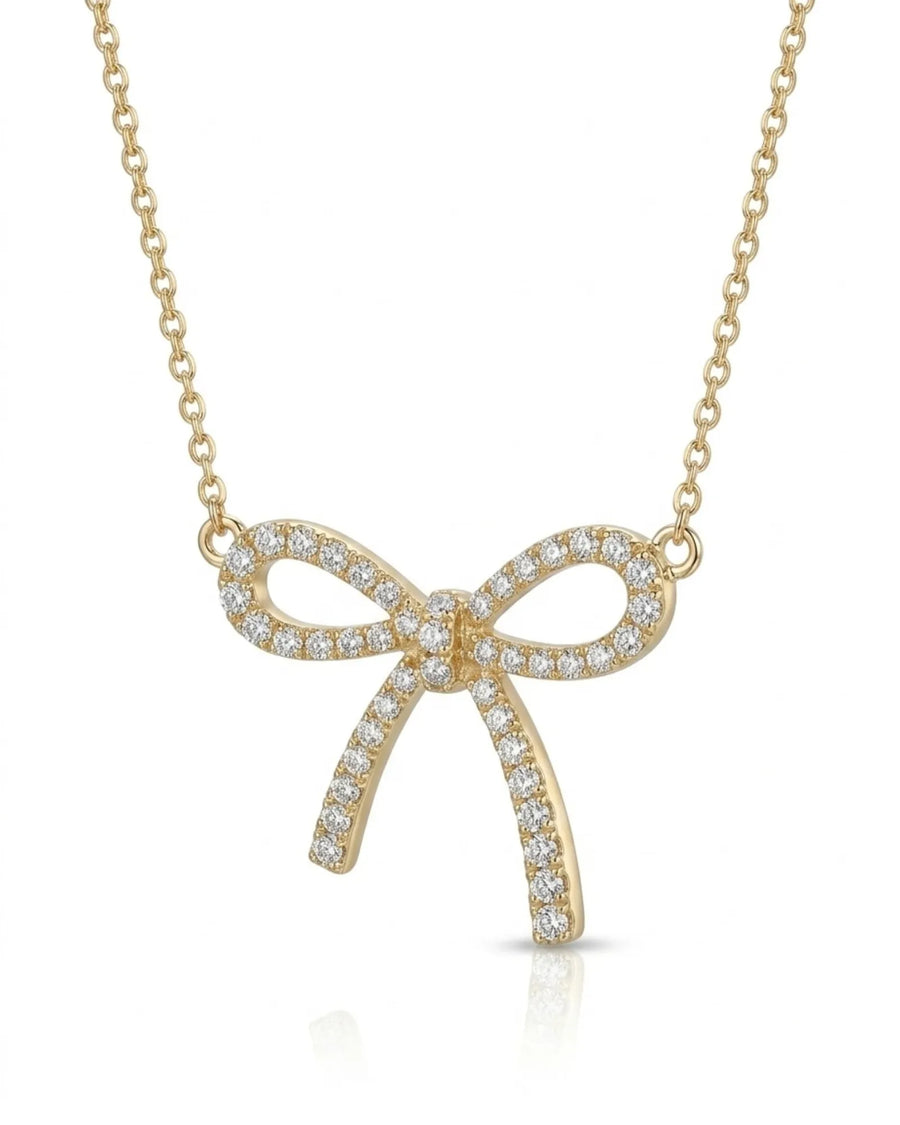 Diamond bow necklace with open ribbon loops and elongated tails in 18K yellow gold | SARATTI