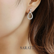 Diamond earring worn by a person with 'SARATTI' branding | SARATII