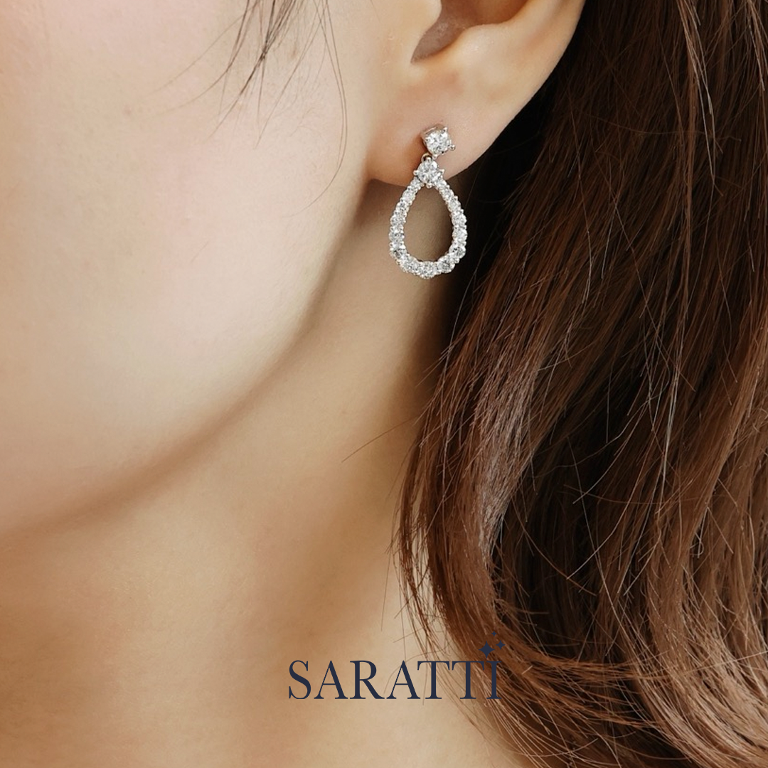 Diamond earring worn by a person with 'SARATTI' branding | SARATII