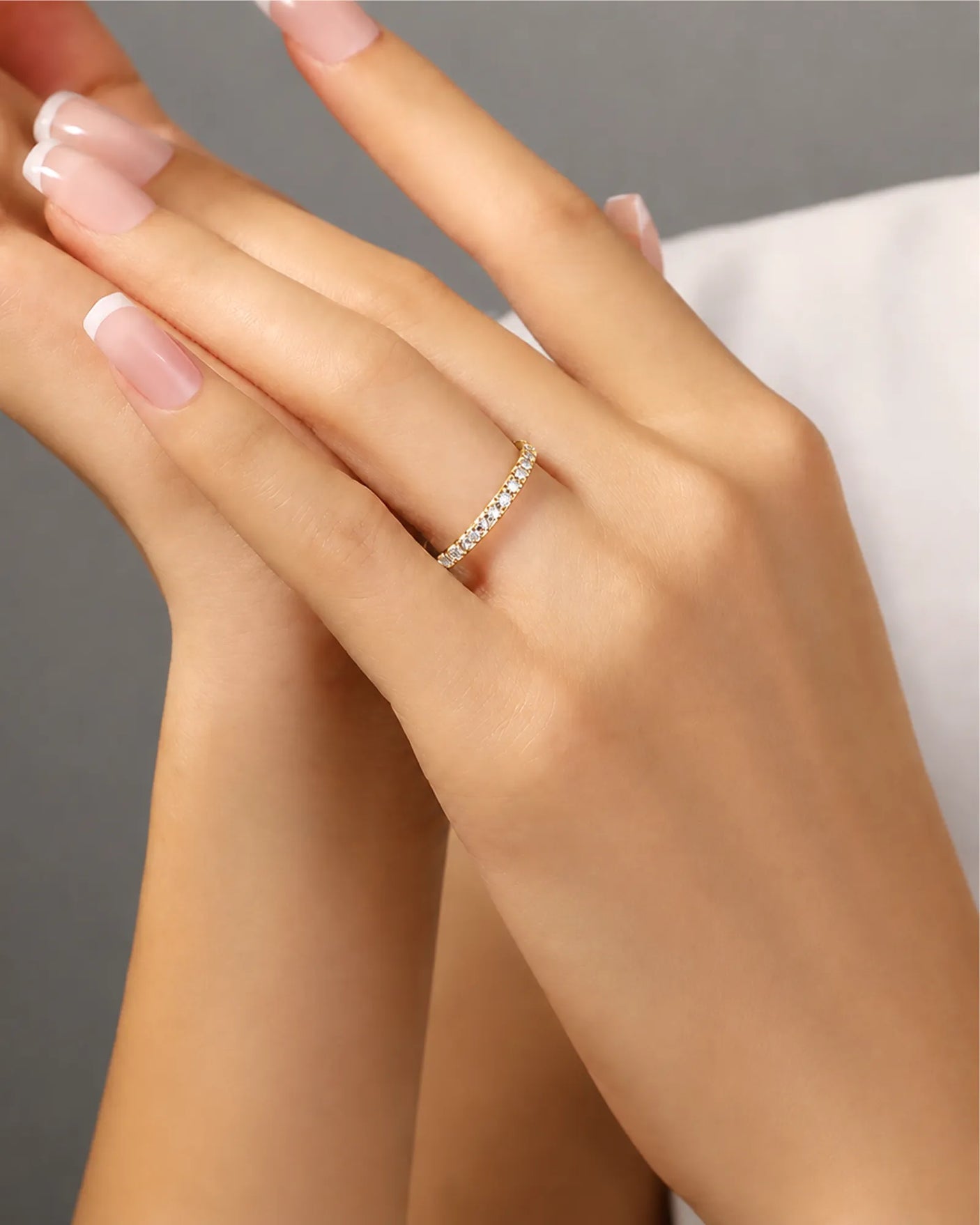 Diamond infinity band highlighting brilliant accent stones across a refined 18K yellow gold design | SARATTI