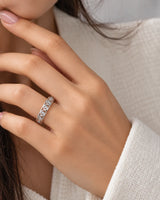 Art Nouveau diamond wedding band styled on a hand, highlighting the flowing ornamental design | SARATTI