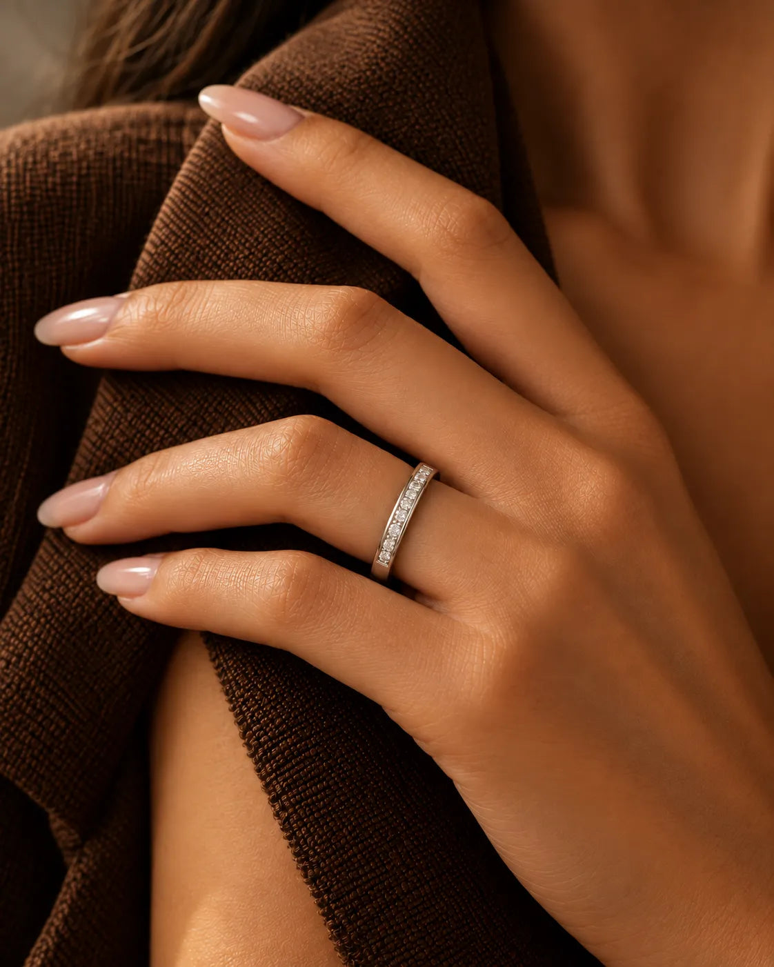 18K white gold channel-set diamond wedding band shown on textured fabric | SARATTI