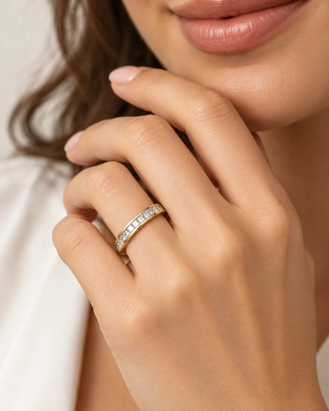Princess-cut diamond wedding band in 18K yellow gold styled on a model | SARATTI