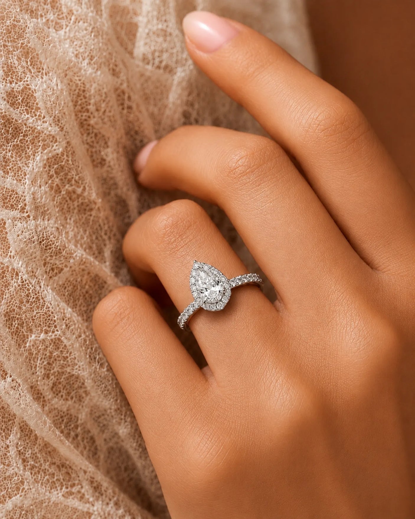 Elegant teardrop moissanite ring with scalloped halo and elevated gallery in 18K white gold | SARATTI