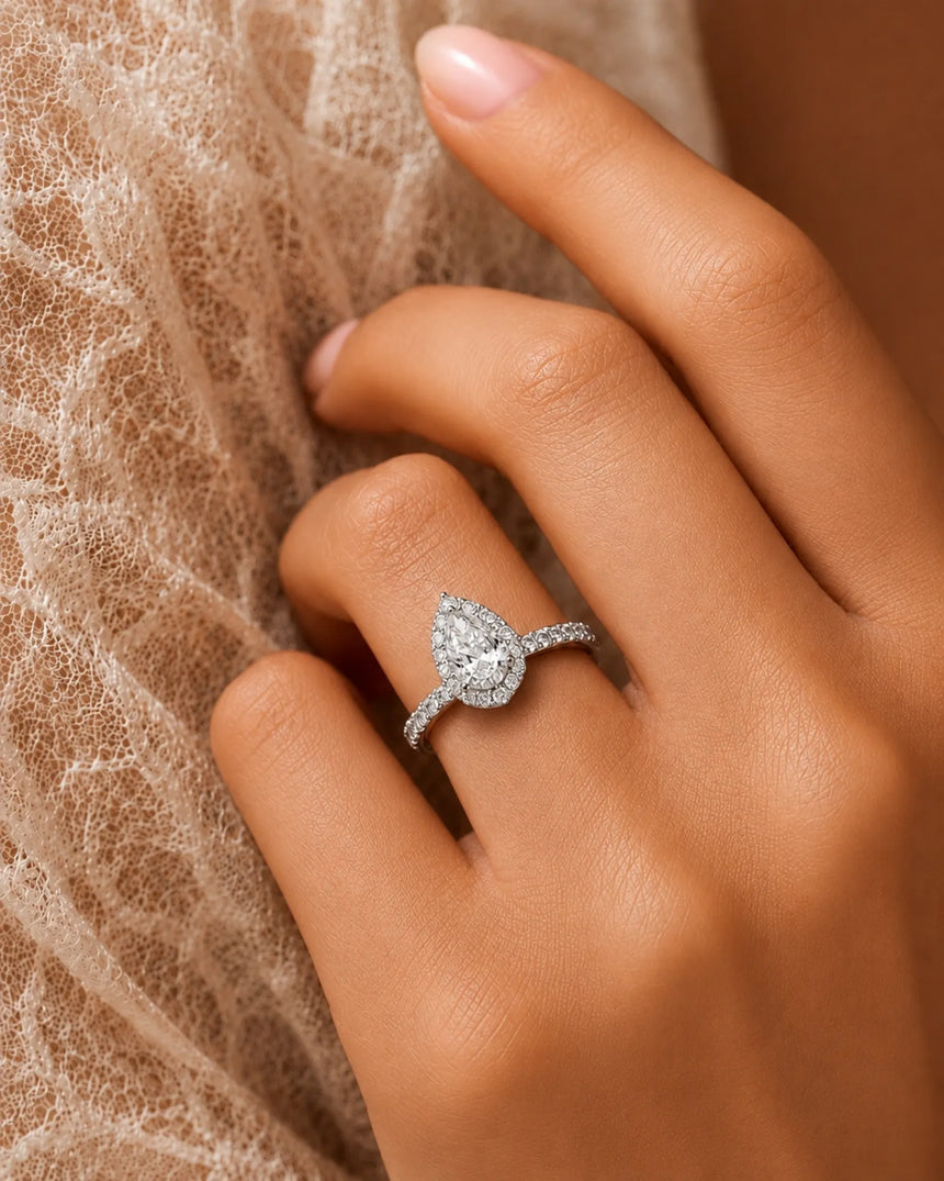 Elegant teardrop moissanite ring with scalloped halo and elevated gallery in 18K white gold | SARATTI