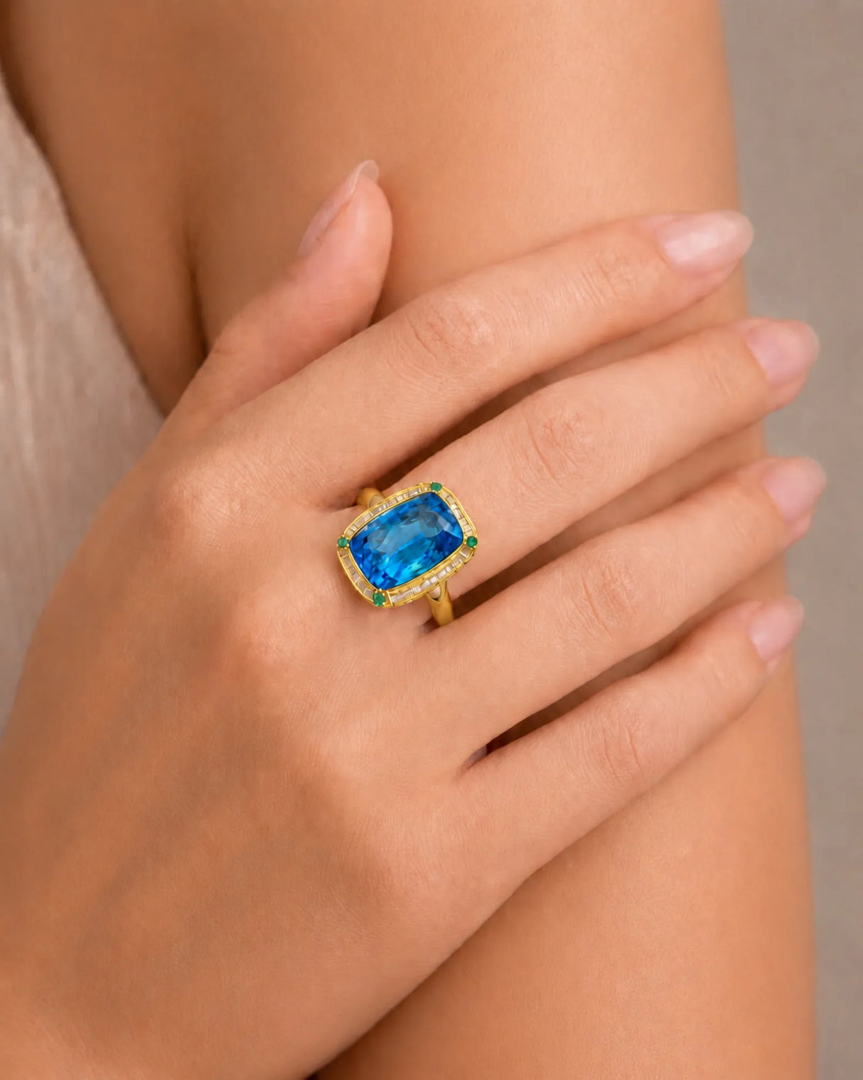 Elongated cushion Swiss Blue topaz ring bordered by baguette diamonds in polished 18K yellow gold | SARATTI