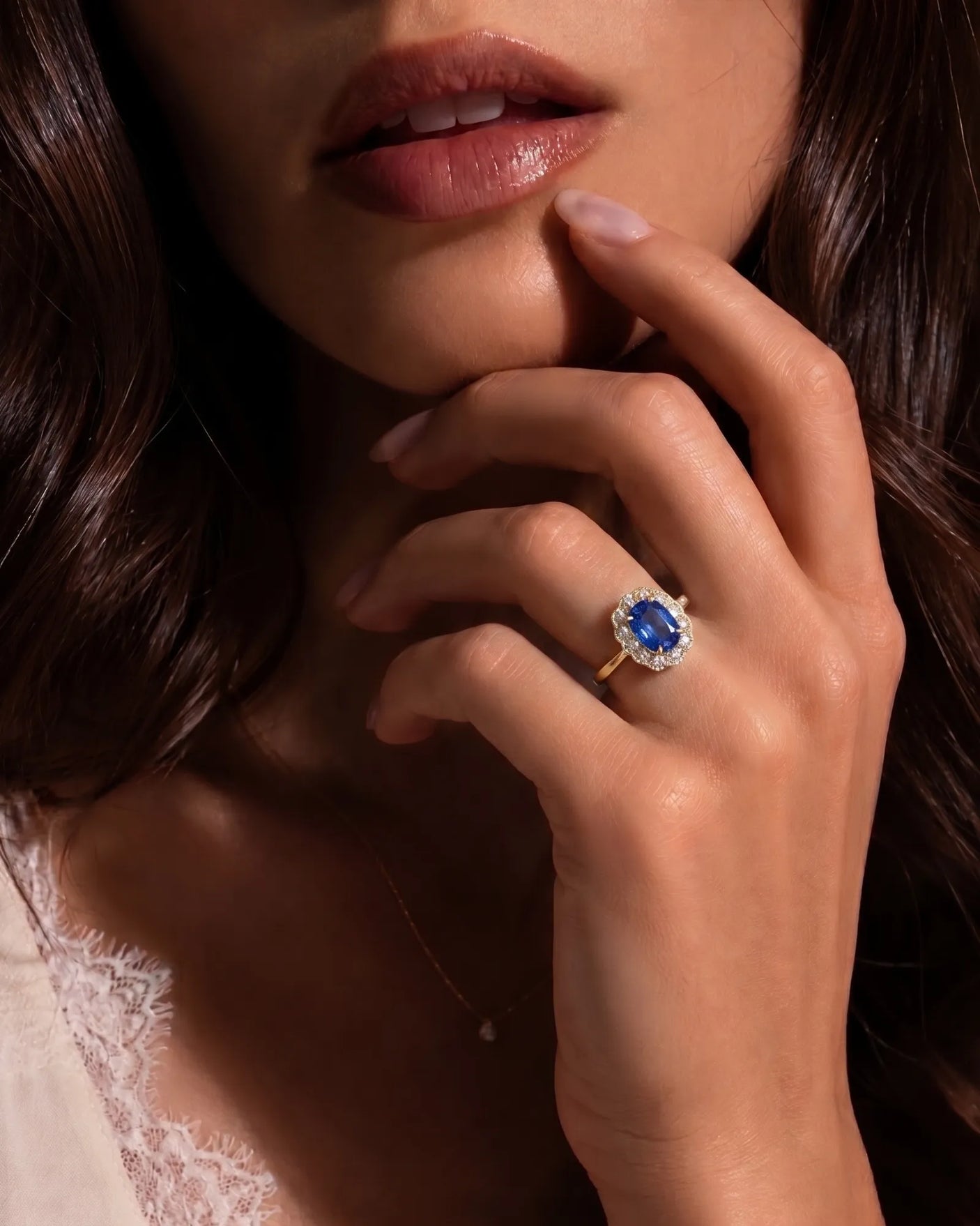 Elongated cushion natural sapphire ring framed by bright diamonds in 18K yellow gold | SARATTI