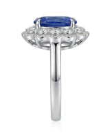 Elongated cushion natural sapphire ring framed by round brilliant diamonds in platinum | SARATTI