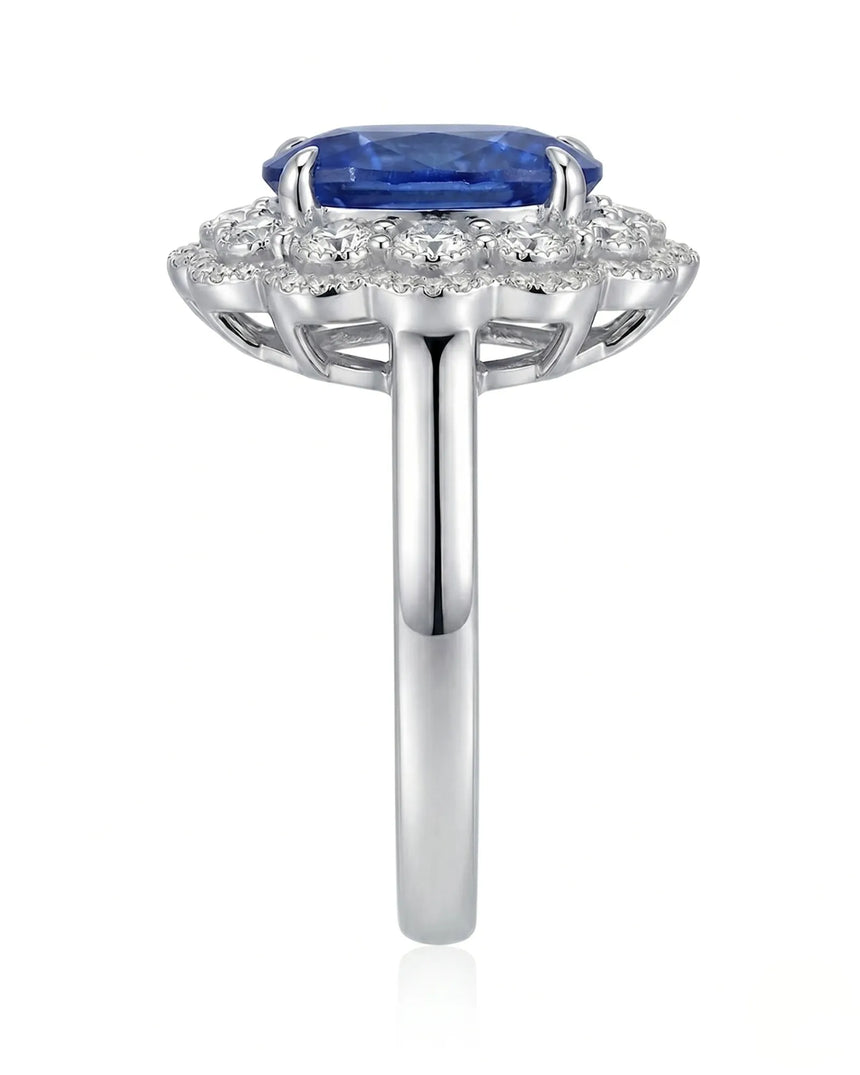 Elongated cushion natural sapphire ring framed by round brilliant diamonds in platinum | SARATTI
