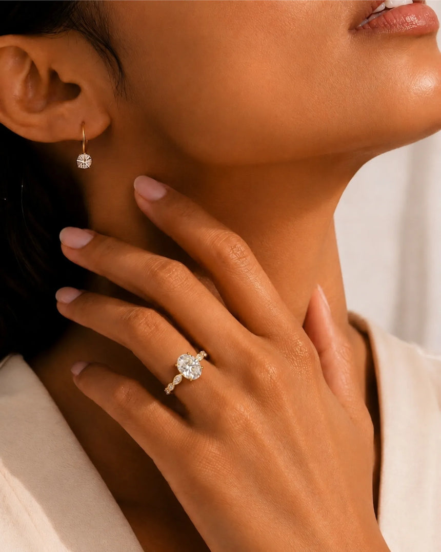 Elongated oval moissanite ring with leaf-like marquise accents and warm 18K yellow gold setting | SARATTI