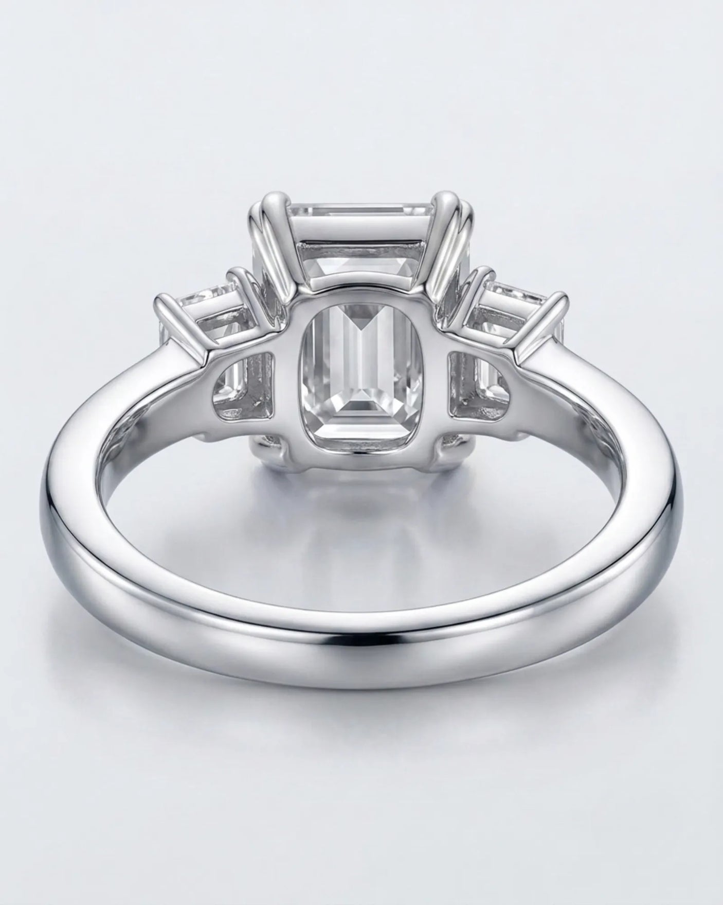 Emerald-cut center diamond framed by step-cut side diamonds in an enduring platinum setting - SARATTI