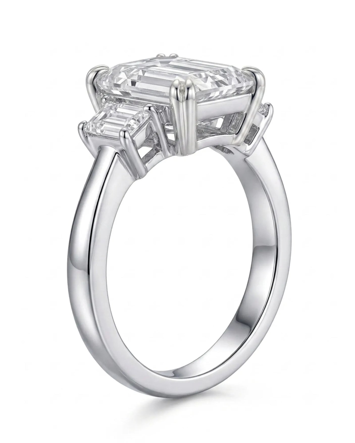Emerald-cut center diamond framed by step-cut side diamonds in an enduring platinum setting | SARATTI