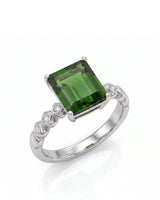 Emerald-cut green tourmaline diamond ring with sculpted geometric shoulders in platinum | SARATTI