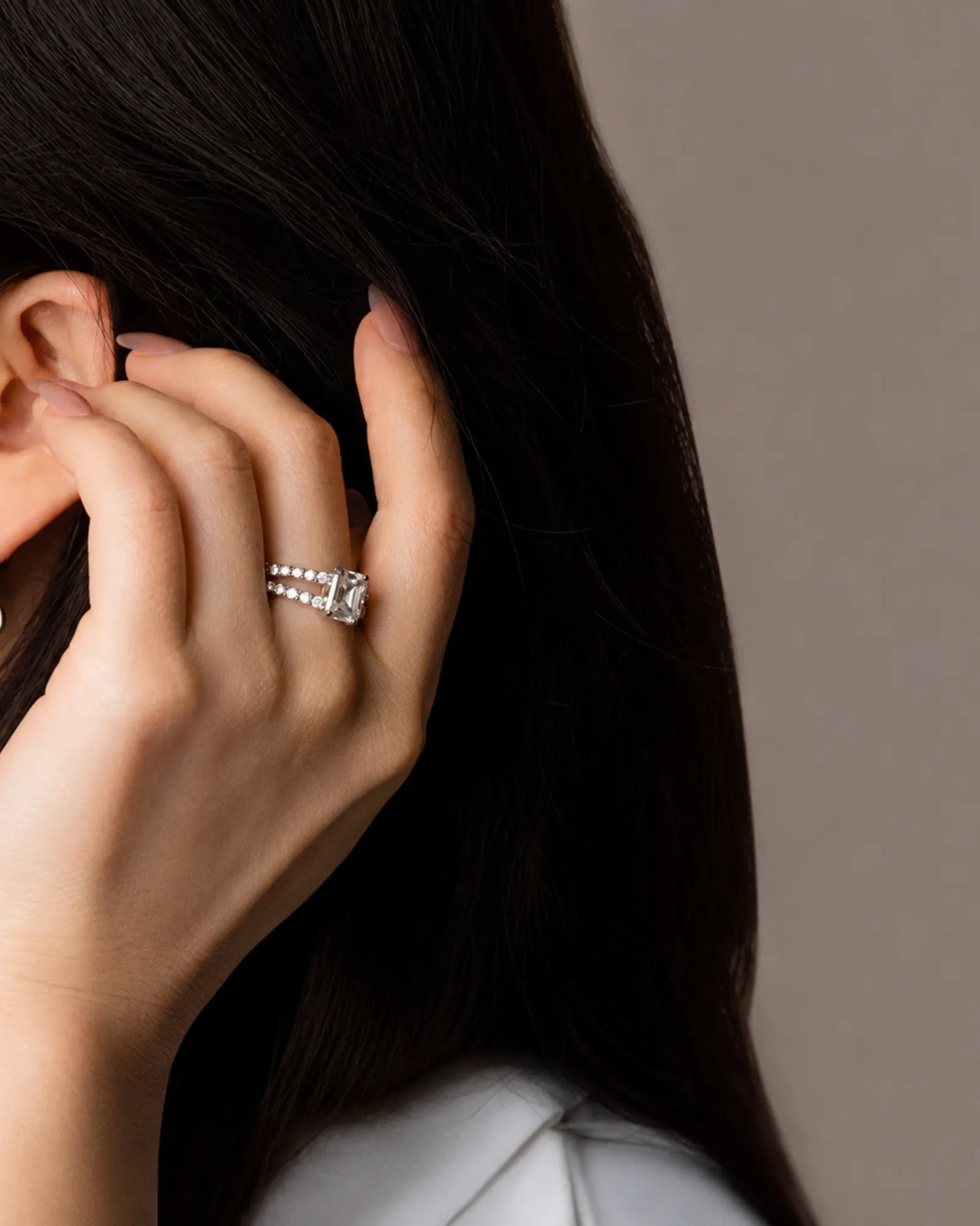 Emerald-cut moissanite ring in white gold with dual pavé bands and elevated profile | SARATTI.