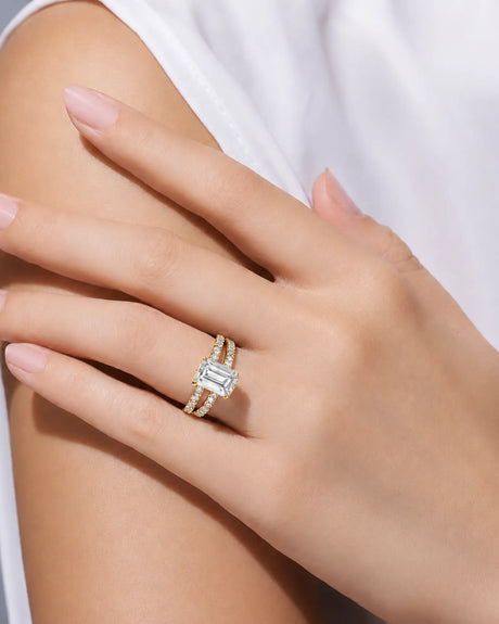 Emerald-cut moissanite ring in yellow gold with dual pavé bands and elevated profile | SARATTI.