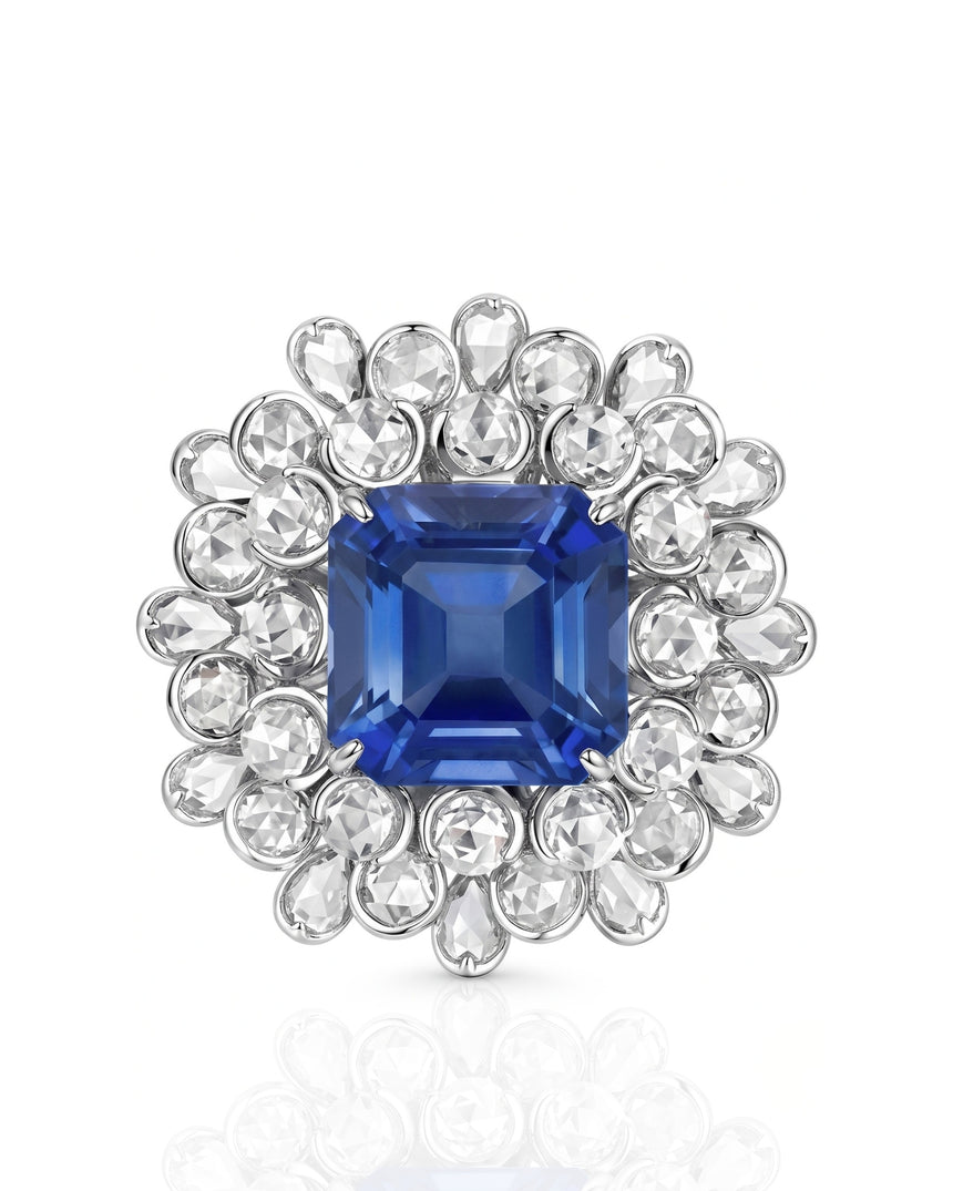 Emerald-cut royal blue sapphire ring framed by luminous diamonds in 18K white gold | SARATTI
