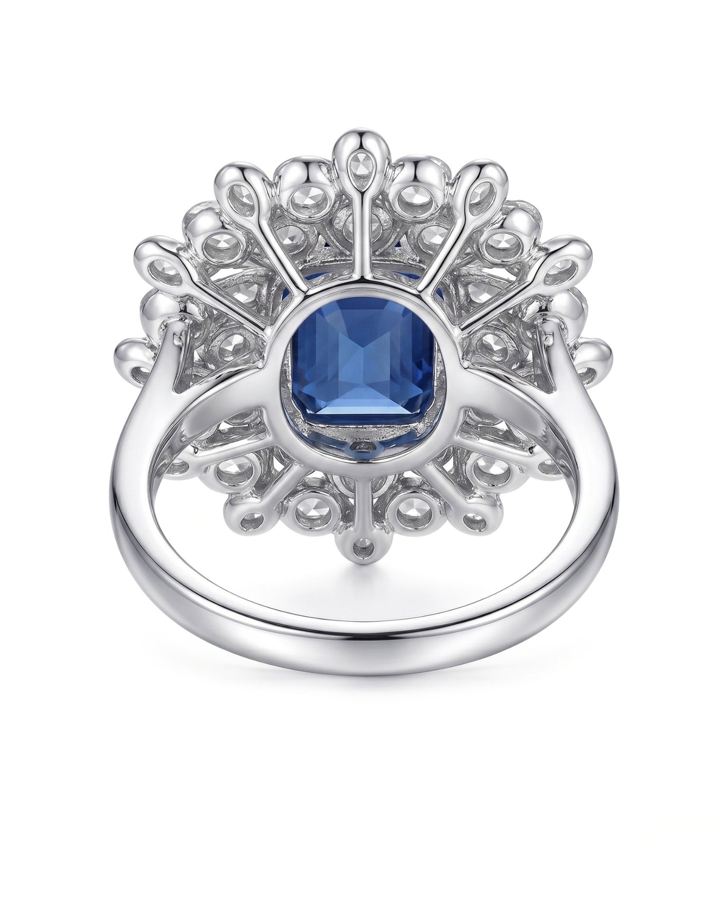 Emerald-cut royal blue sapphire ring framed by white diamonds in platinum | SARATTI