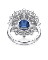 Emerald-cut royal blue sapphire ring framed by white diamonds in platinum | SARATTI
