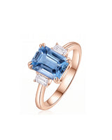 Emerald cut aquamarine engagement ring with diamond side stones in 18K Rose Gold | SARATTI