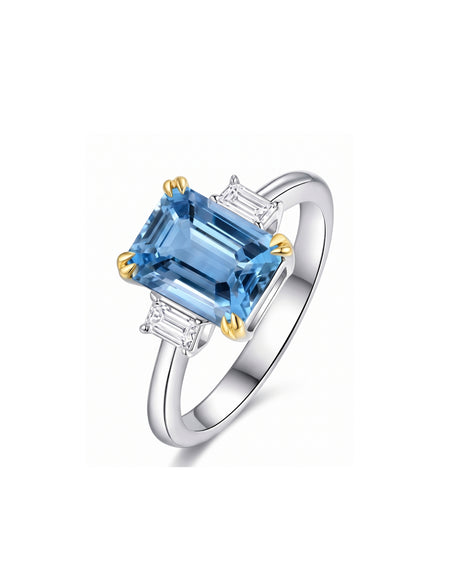 Emerald cut aquamarine engagement ring with diamond side stones in 18K two tone Gold | SARATTI