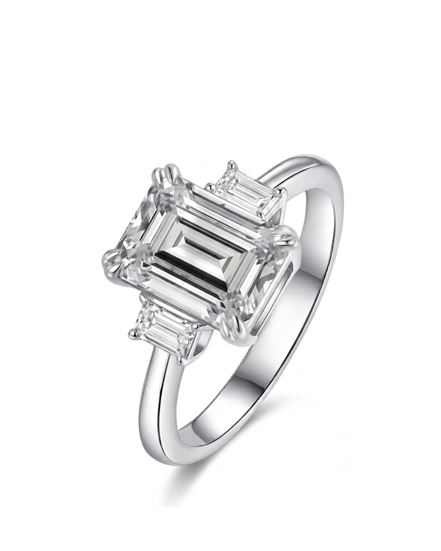 Emerald cut moissanite three stone engagement ring with matching side stones crafted in platinum | SARATTI