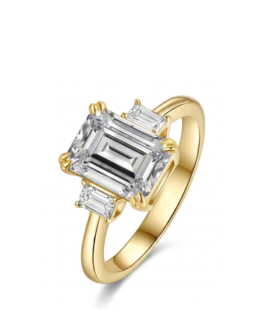 Emerald cut moissanite three stone engagement ring with matching side stones in 18K yellow gold | SARATTI