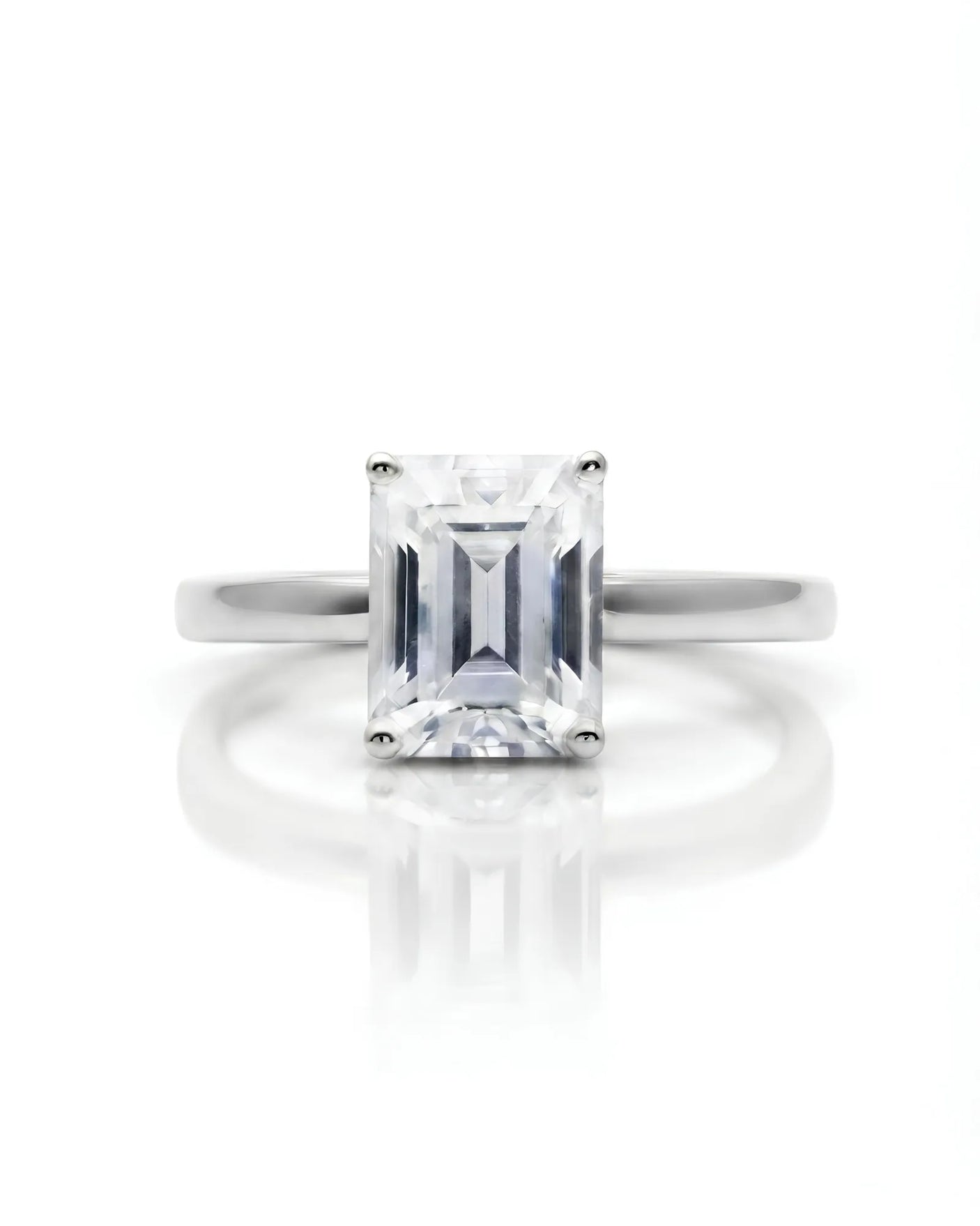 Emerald moissanite solitaire ring in platinum with architectural basket and clean minimalist profile | SARATTI