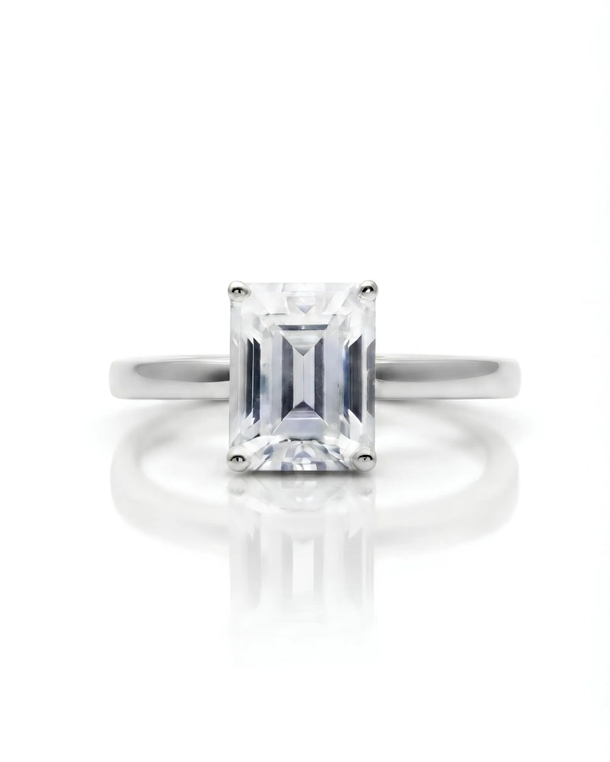 Emerald moissanite solitaire ring in platinum with architectural basket and clean minimalist profile | SARATTI
