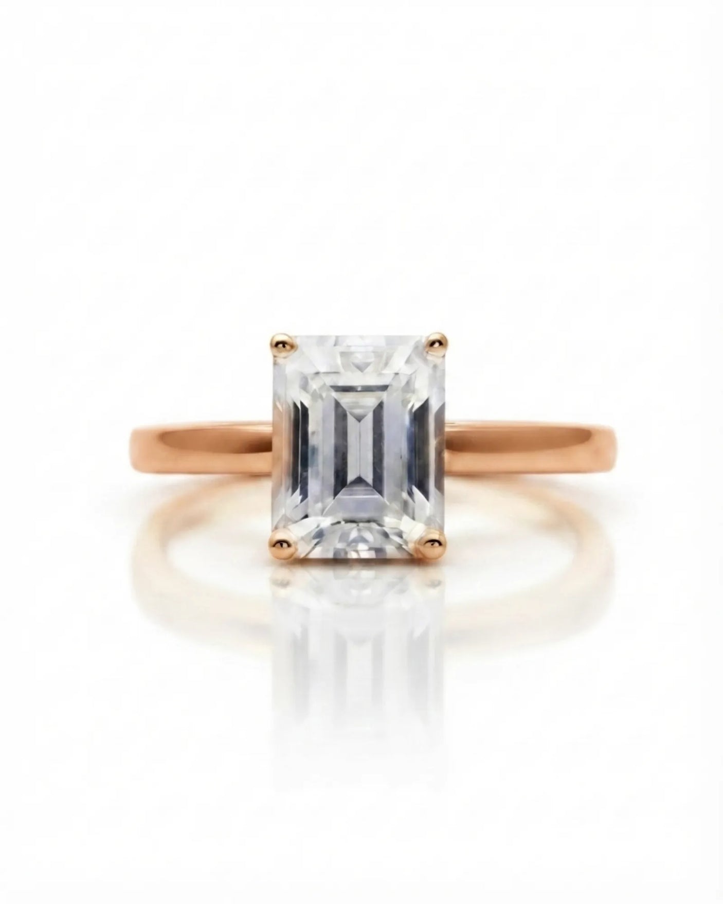 Emerald moissanite solitaire ring in rose gold with architectural basket and clean minimalist profile | SARATTI