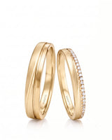 Eternal Waves his and hers wedding ring set with flowing polished design in 18K yellow gold | SARATTI