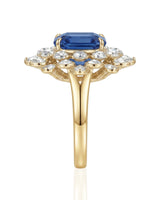 Floral halo sapphire ring with round and pear diamonds in warm 18K yellow gold | SARATTI