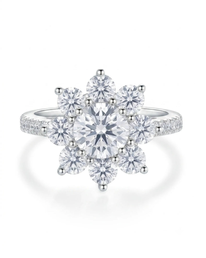 Floral moissanite ring with round center and eight petal-like accents in 18K white gold | SARATTI