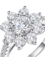 Floral moissanite ring with round center and eight petal-like accents in polished platinum | SARATTI