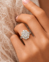 Floral oval moissanite ring with layered side stones and pavé split band in two tone | SARATTI
