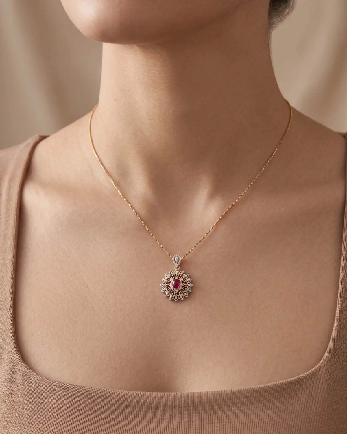 Floral ruby pendant featuring layered diamond petals and intricate 18K two tone gold openwork | SARATTI