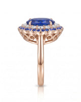 Floral sapphire ring with round diamond halo and blue sapphire border in 18K rose gold | SARATTI