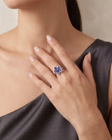 Floral sapphire statement ring with sculpted five-petal design and delicate diamond borders in 18K gold | SARATTI