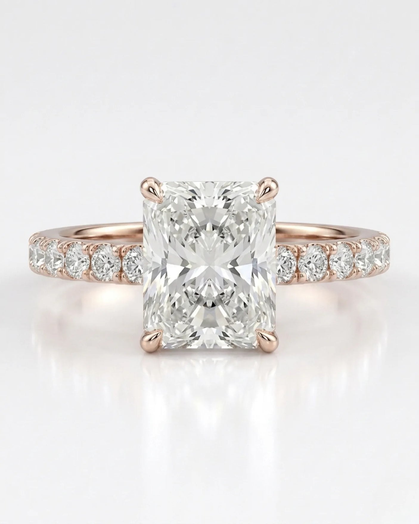 Four-prong radiant diamond ring with round pavé shoulder stones and an 18K rose gold band | SARATTI