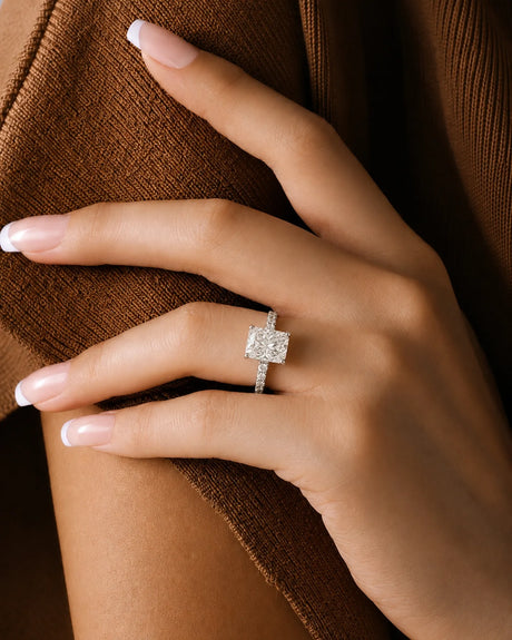 Four-prong radiant diamond ring with round pavé shoulder stones and an enduring platinum band | SARATTI