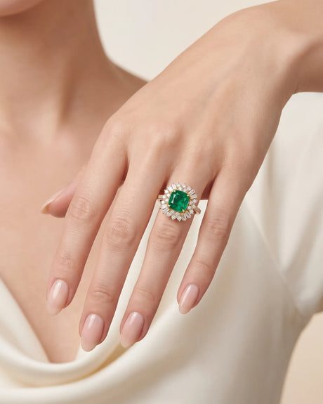 Front view of 1.35 ct cushion emerald ring with round and baguette diamond starburst halo | SARATTI