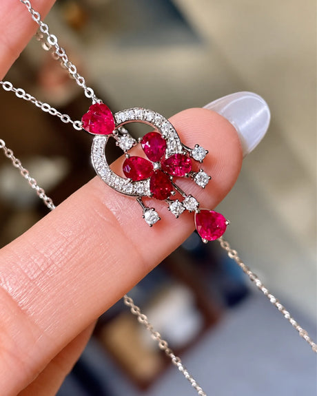 Front view of ruby flower dreamcatcher pendant with diamond circular frame in platinum | SARATTI