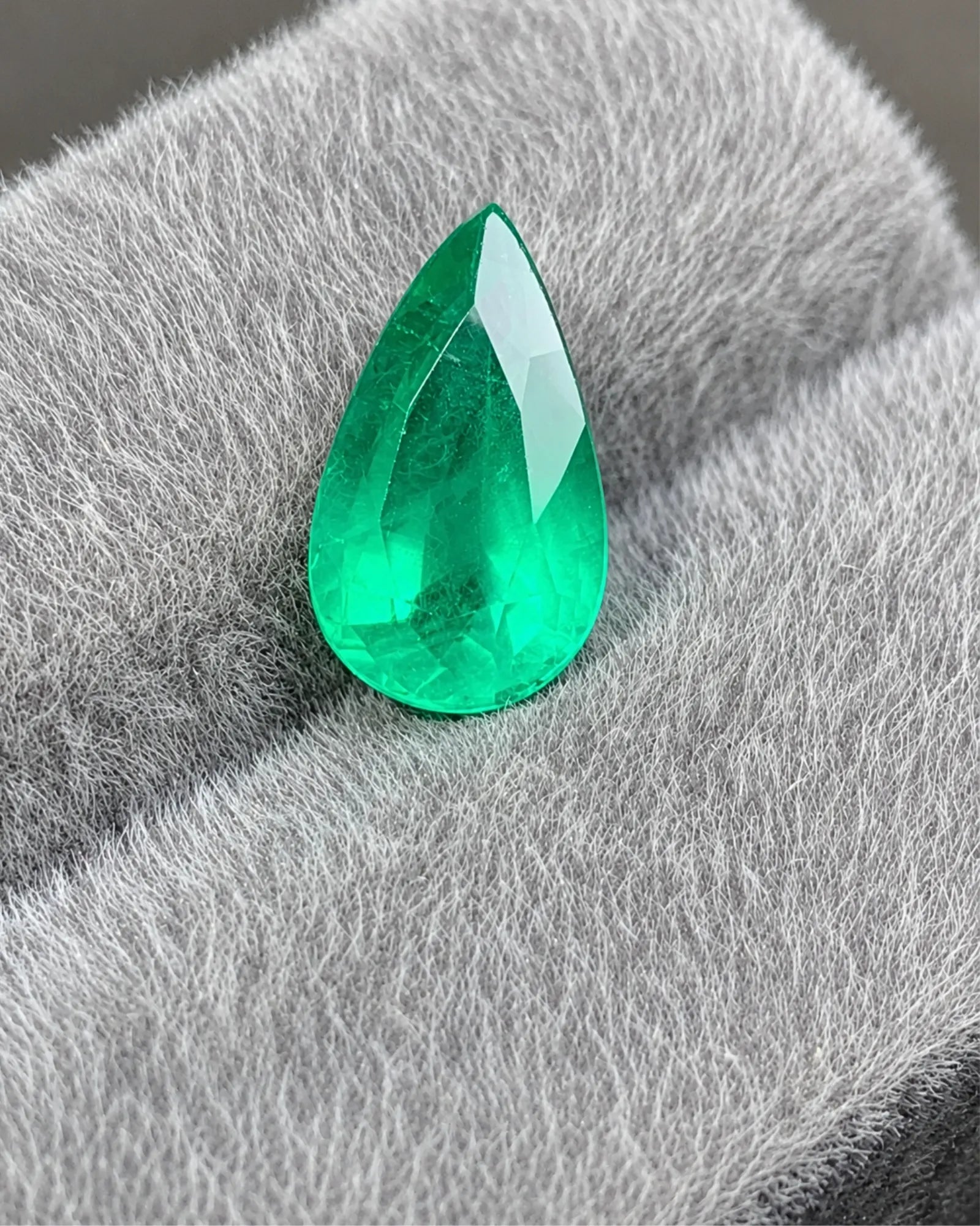 GUILD-certified Natural Emerald pear gemstone shown at an alternate angle | SARATTI