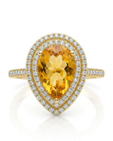 Golden pear-cut citrine surrounded by brilliant diamond halos in a polished 18K yellow gold ring | SARATTI