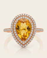 Golden pear-cut citrine surrounded by brilliant diamonds in a warm 18K rose gold ring | SARATTI