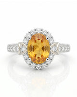 Golden yellow oval sapphire ring with natural diamond accents in 18K white gold | SARATTI