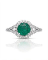 Green emerald ring framed by a brilliant moissanite halo in polished platinum | SARATTI.