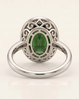 Green tourmaline engagement ring with diamond halo in premium platinum | SARATTI