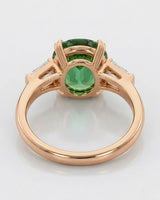 Green tourmaline engagement ring with emerald-cut diamond accents in 18K rose gold | SARATTI